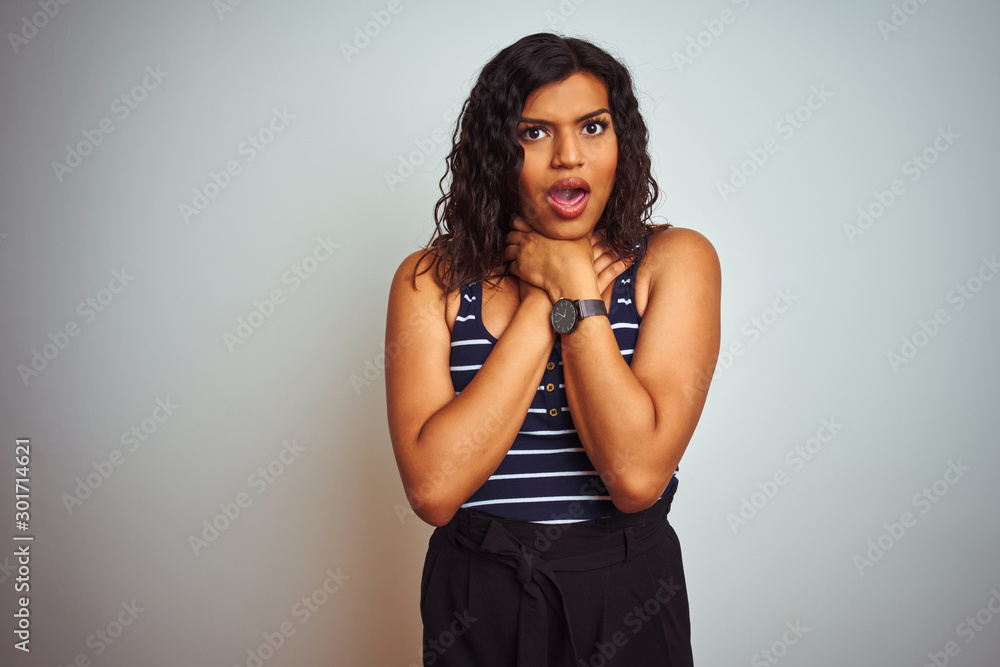 Naklejka premium Transsexual transgender woman wearing striped t-shirt over isolated white background shouting suffocate because painful strangle. Health problem. Asphyxiate and suicide concept.