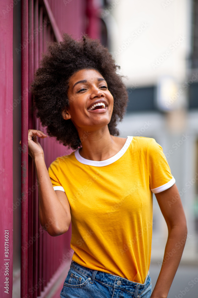 beautiful african american woman laughing outside in city beautiful african american woman laughing outside in city