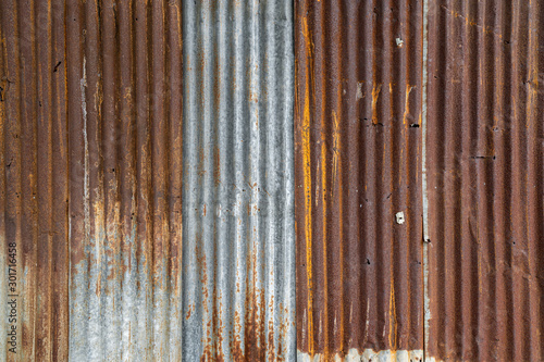Rusted galvanized iron plate, red stain on old metal sheet wall texture.