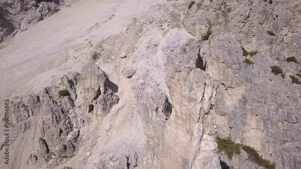 Drone aerial video to the spectacular dolomite rocks peaks in the Tofana area near Cortina D'Ampezzo.Autumn season, top down dynamic perspective. Drone aerial video to the spectacular dolomite rocks peaks in the Tofana area near Cortina D'Ampezzo.Autumn season, top down dynamic perspective.