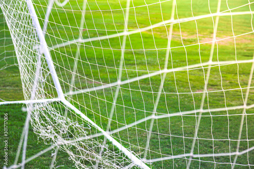 Close up of football soccer goal net with green grass