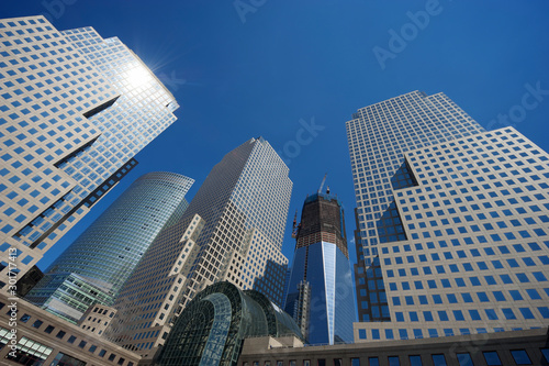 Sunny blue sky view of classic city skyline with shiny glass office tower skyscrapers