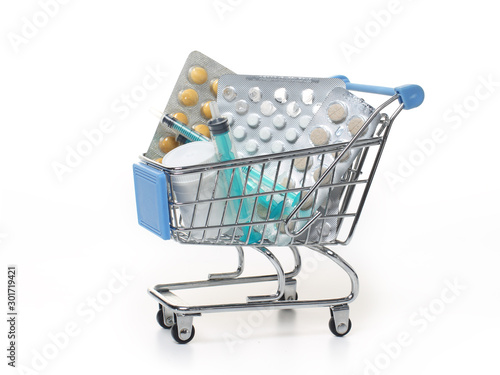 Pills and syringes in a shopping cart. The concept of buying drugs.