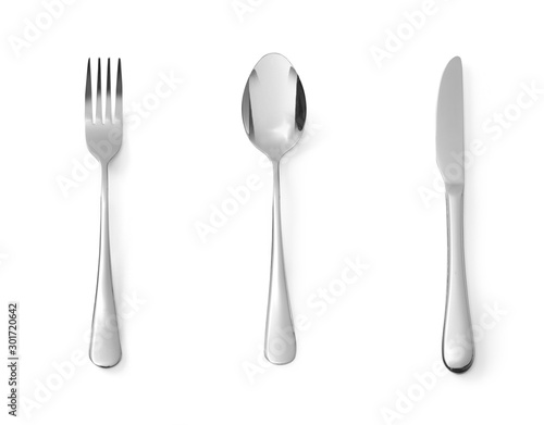 Fotografiet Set of dessert cutlery spoon fork and knife stainless steel isolated on white ba