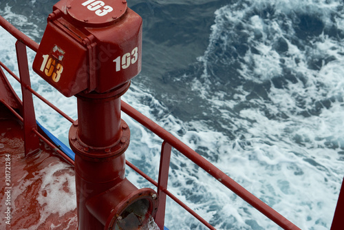 View of Ballast Water exchange process onboard of a ship using flow-through method underway in open ocean. Overflow method through ballast tank air head. photo