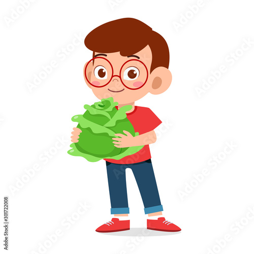 happy cute kid boy holding fresh vegetable