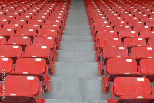 Red stadium seats sport outdoor horizontal row seating.