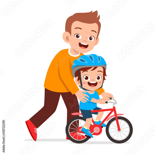 happy cute kid boy riding bike with dad