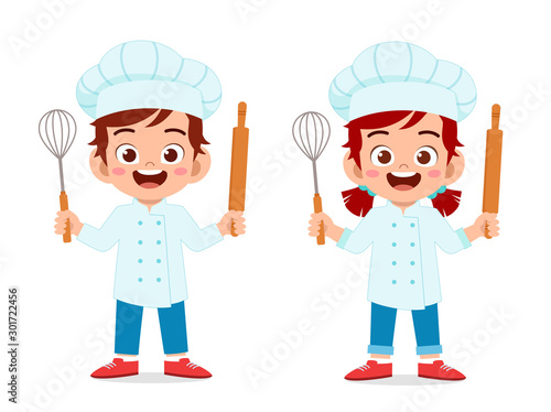 happy cute kid boy and girl in chef costume