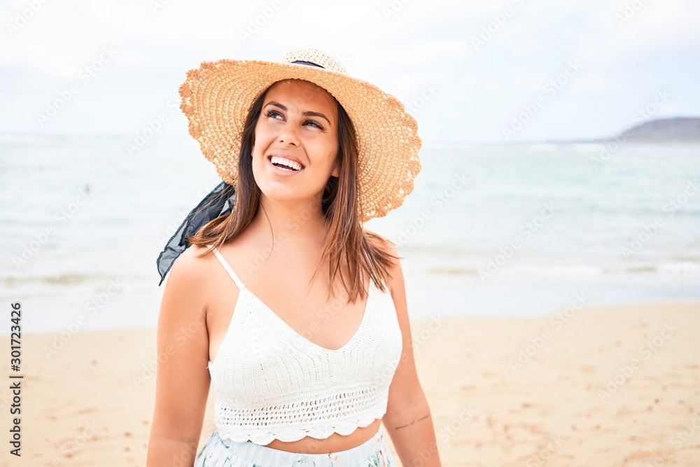 Young beautiful woman smiling happy enjoying summer vacation at the beach Young beautiful woman smiling happy enjoying summer vacation at the beach