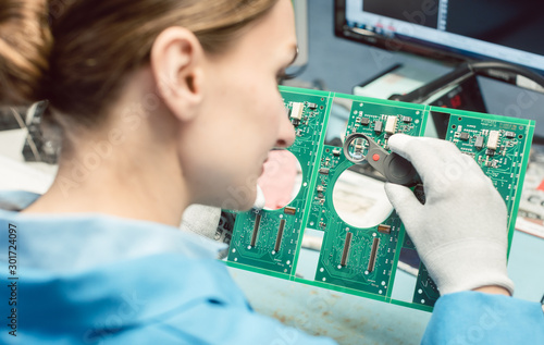 Фотография Technician soldering components to a PCB