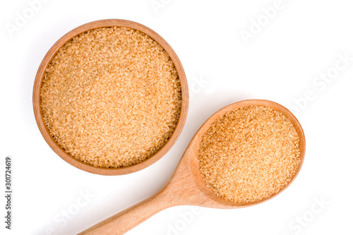 Closeup brown sugar in wooden bowl and spoon isolated on white background . Unhealthy diet ,awareness and stop diabetes concept. Top view. Flat lay.