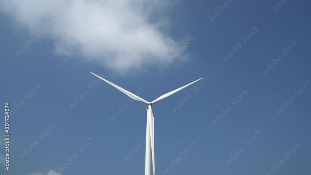 Wind turbines on blue sky background, Wind Turbine producing alternative energy. Ecology and nature conservation, Close-up shot Wind turbines on blue sky background, Wind Turbine producing alternative energy. Ecology and nature conservation, Close-up shot