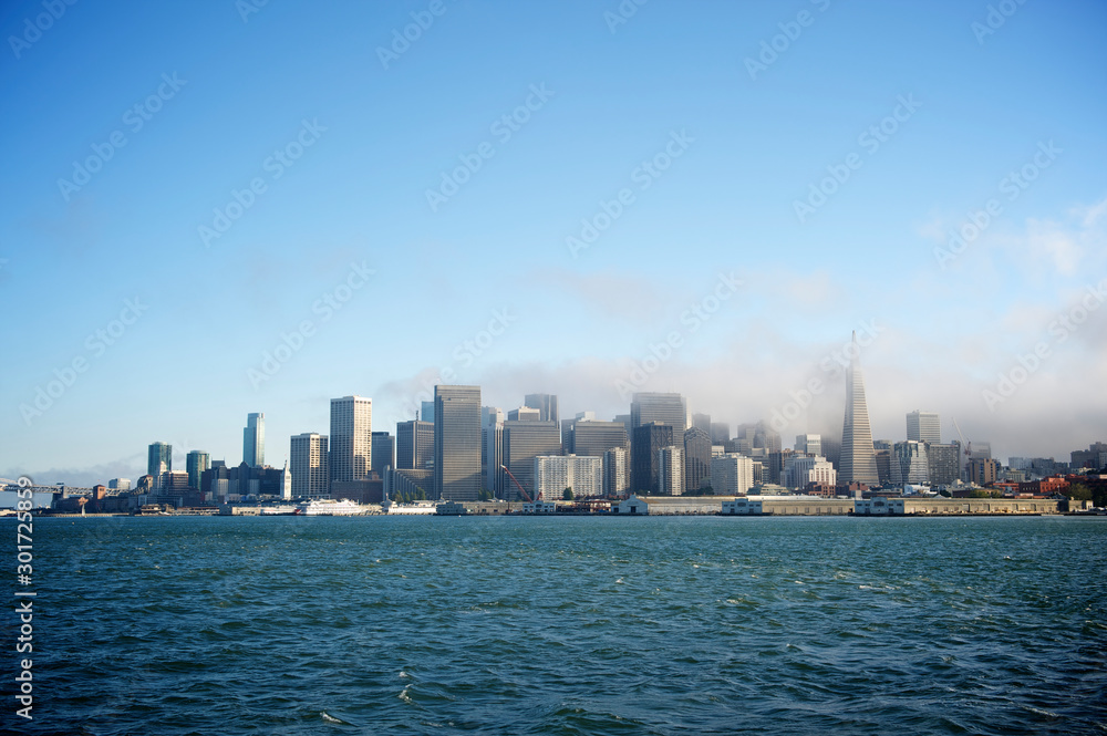 Scenic daytime view of the city skyline of San Francisco with fog rolling in over the bay