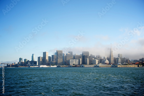 Scenic daytime view of the city skyline of San Francisco with fog rolling in over the bay