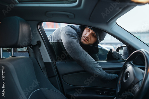 Car robber opening door, risk job, stealing © Nomad_Soul