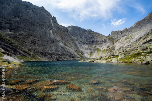 Fototapeta Naklejka Na Ścianę i Meble -  A magnificent mountain lake surrounded by cliffs