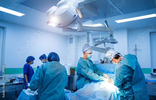 Medical team hospital performing operation. Group of surgeon at work in operating room. healthcare.