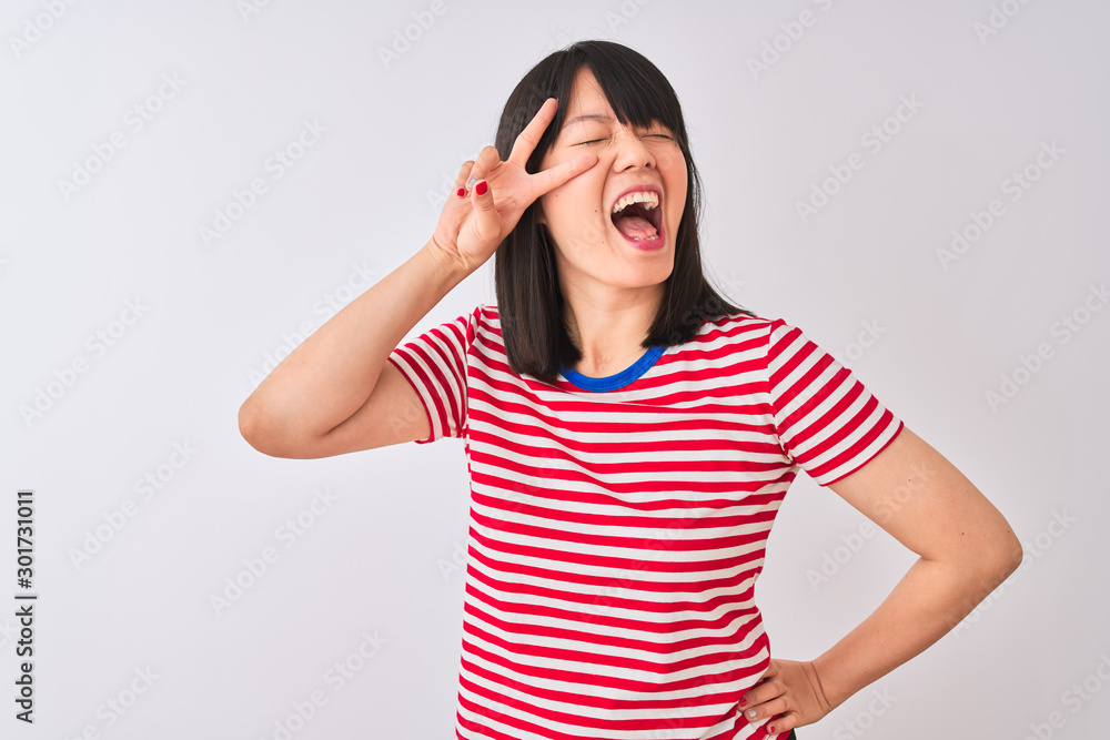 Young beautiful chinese woman wearing red striped t-shirt over isolated white background Doing peace symbol with fingers over face, smiling cheerful showing victory Young beautiful chinese woman wearing red striped t-shirt over isolated white background Doing peace symbol with fingers over face, smiling cheerful showing victory