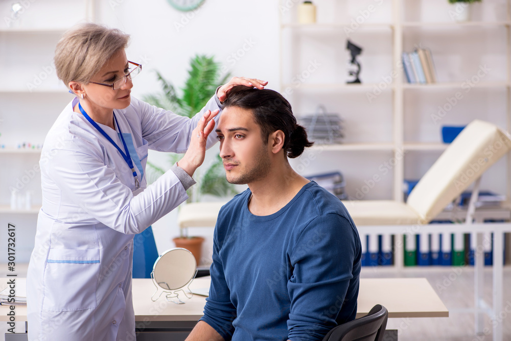 Fototapeta premium Young patient visiting doctor in hospital