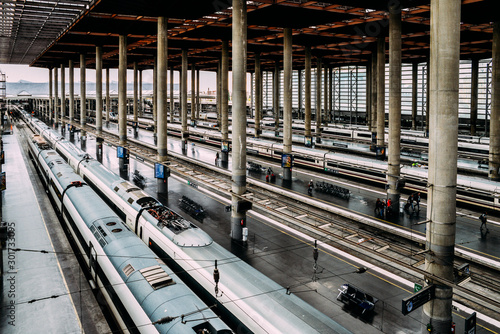 High perspective view of passengers and trains at Atocha, the the main railway station in Madrid, Spain photo