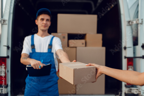 Deliveryman gives parcel to buyer, delivering © Nomad_Soul