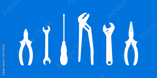 White vector tools for repair isolated on blue background.
