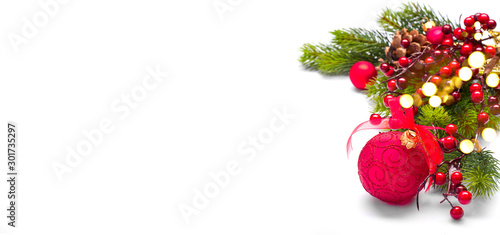 Red Christmas and New Year Decoration isolated on white background. Border art design with holiday baubles. Beautiful Xmas tree closeup decorated with balls, holly berry. Space for text
