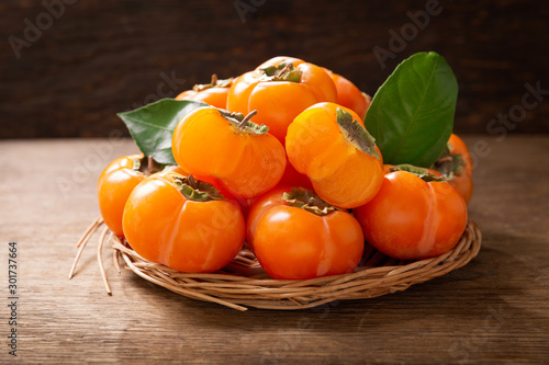 ripe persimmon fruit on a wooden board