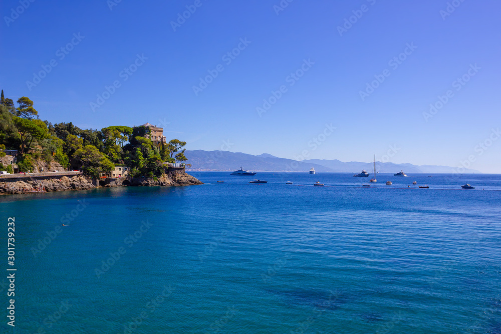 The beach near portofino in genoa on a blue sky and sea background