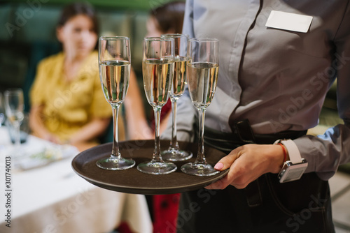 A waiter holding tray with champagne glasses at the restaurant © rostyslav84