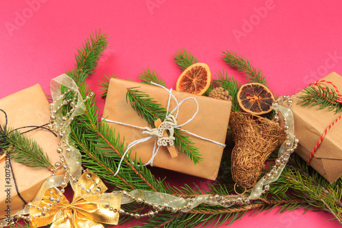 Christmas border. Christmas gifts, fir branches on color background. Flat lay, top view, copy space - Image