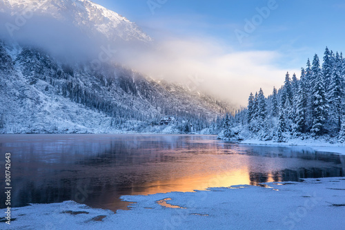 Winter sunrise over scenic frozen lake © alexugalek
