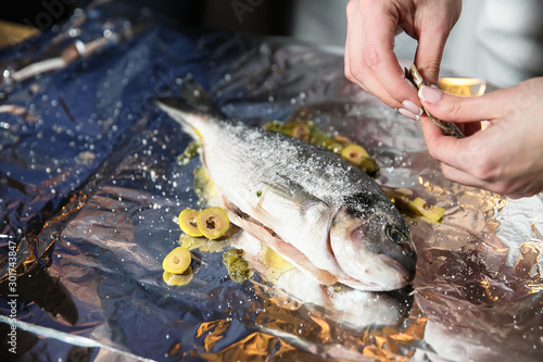 Fototapeta Naklejka Na Ścianę i Meble -  Hands carve fish, delicious food sentence