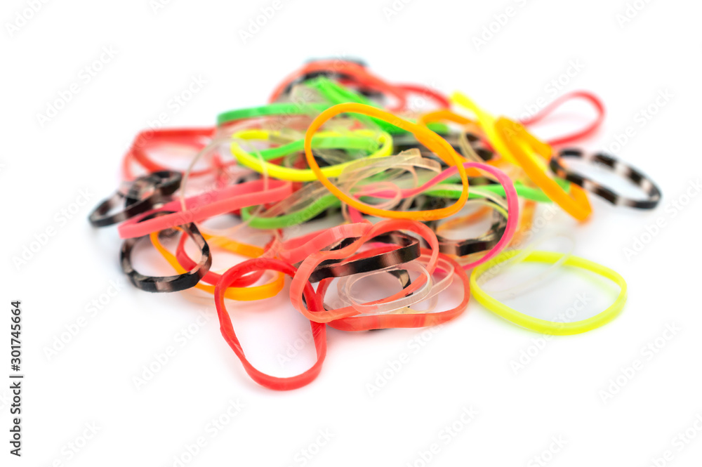 Heap of children rubber bands for hair on white. Heap of children rubber bands for hair on white.