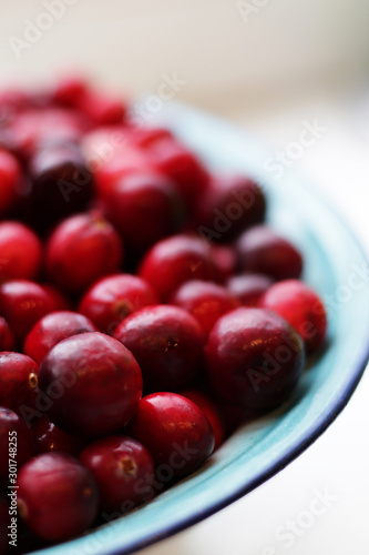 lot of fresh cranberries in a bowl close up