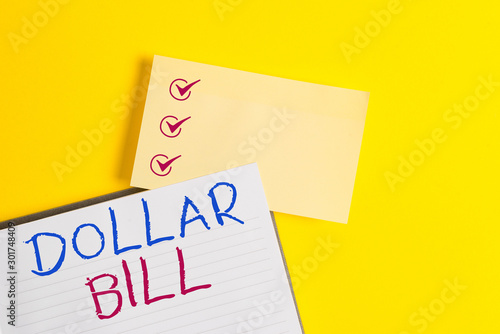 Conceptual hand writing showing Dollar Bill. Concept meaning a piece of paper money worth one dollar Federal Reserve note Empty orange paper with copy space on the yellow table