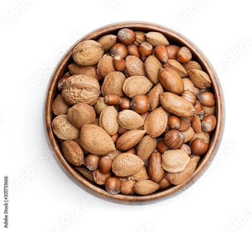 Wooden bowl with mixed nuts isolated on white