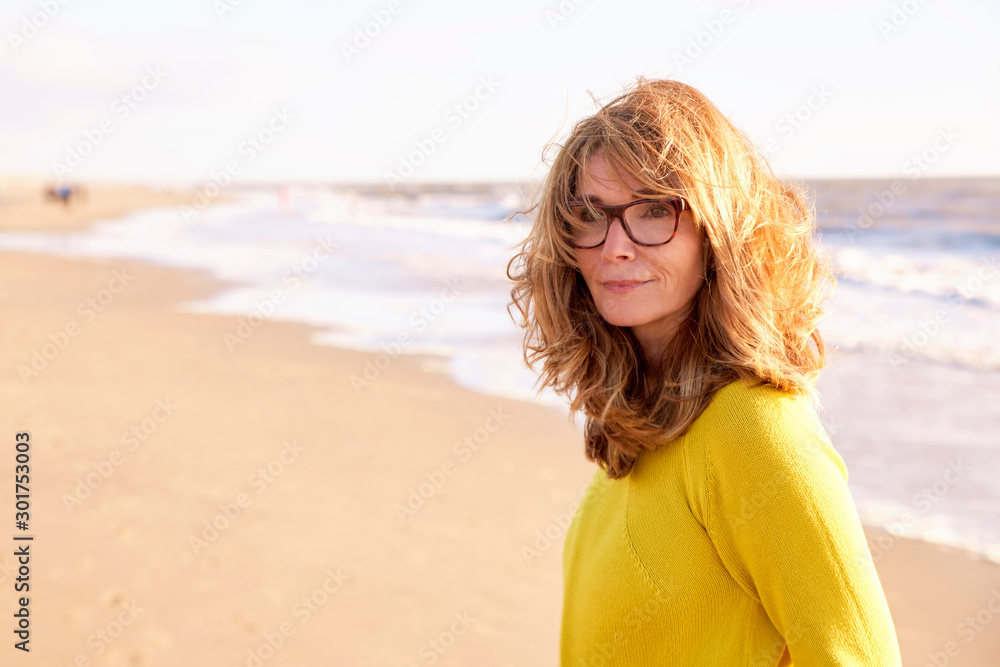 Close-up portrait of attractive middle aged woman relaxing on the beach Close-up portrait of attractive middle aged woman relaxing on the beach