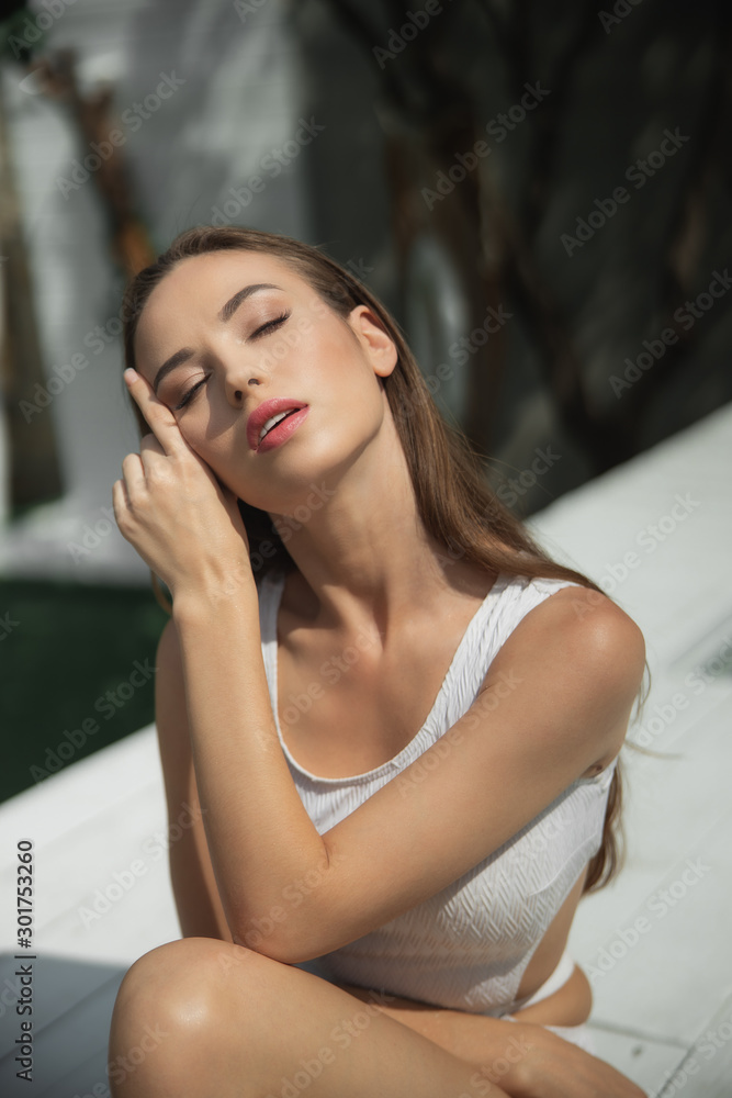 Fototapeta premium Elegant young woman relaxing with eyes closed