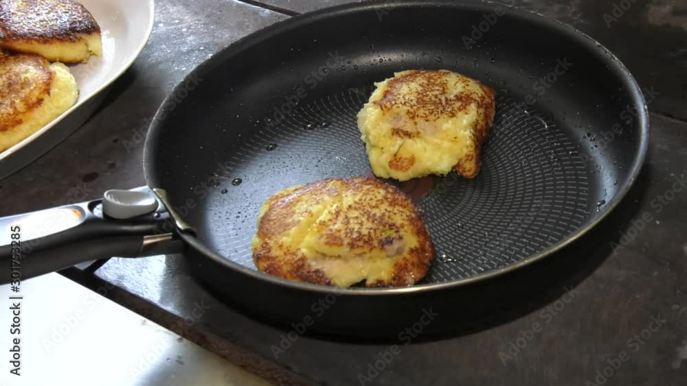 Homemade food. Fresh tasty pancakes close-up. Potato pancakes are fried in a pan. potato pancakes frizzle in black frying pan Homemade food. Fresh tasty pancakes close-up. Potato pancakes are fried in a pan. potato pancakes frizzle in black frying pan