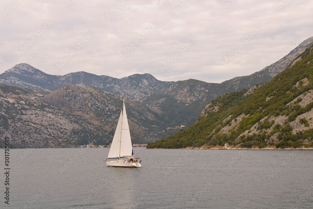 Sailing yacht in the sea Bay on the background of the mountains.