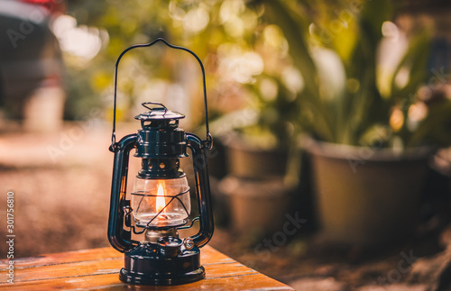 vintage lantern hanging on the table in the evening photo