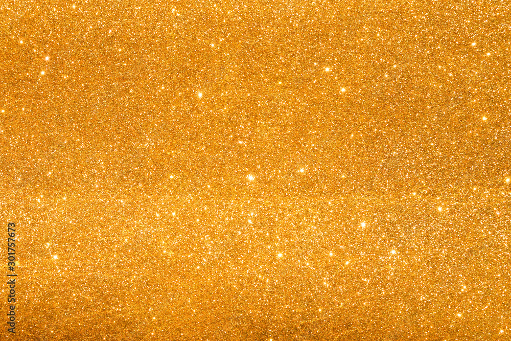 shine and sparkle of golden glitter abstract background	