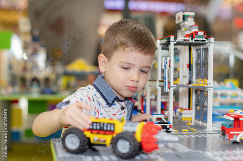 Children play with educational toys. Children sit on the carpet in the playroom at home or in the kindergarten.boy with toy cars