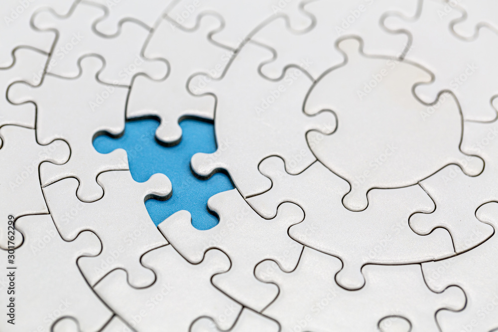 Unfinished white jigsaw puzzle pieces on blue background, The last missing  piece of the jigsaw puzzle. Photos | Adobe Stock