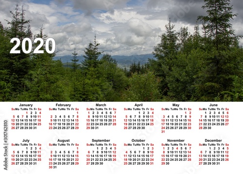 Wall calendar for the whole year. Corporate, home and business calendar. 2020 calendar in table. Calendar on a background mountains, sunset and flowers