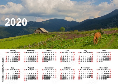 Wall calendar for the whole year. Corporate, home and business calendar. 2020 calendar in table. Calendar on a background mountains, sunset and flowers