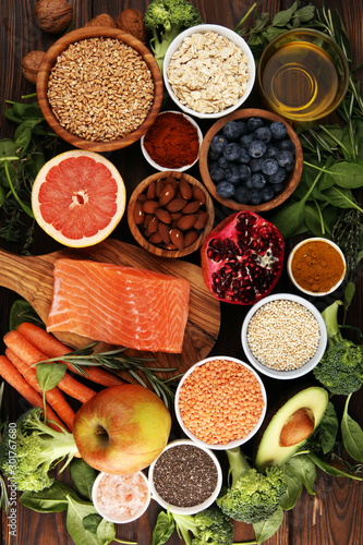 Fototapeta Naklejka Na Ścianę i Meble -  Healthy food clean eating selection: fish, fruit, vegetable, cereal, leaf vegetable on rustic background