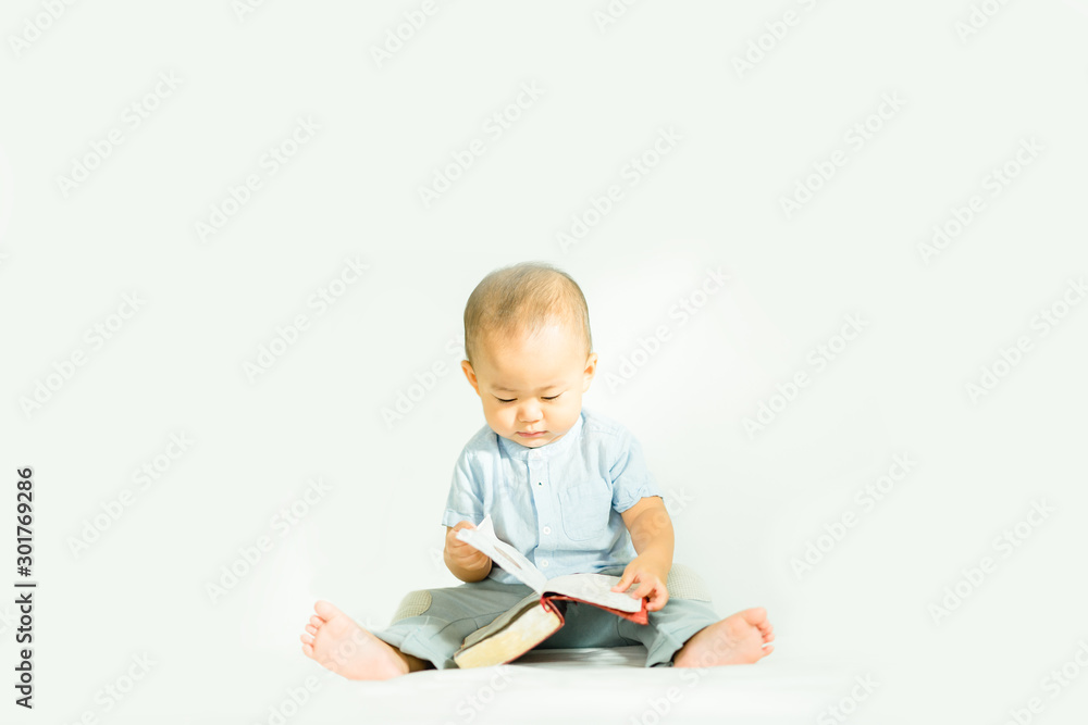 Cute asian baby boy read on a Holy Bible for faith and bible study and teach kid in the way of GOD.Concept for faith, spirituality and religion. Cute asian baby boy read on a Holy Bible for faith and bible study and teach kid in the way of GOD.Concept for faith, spirituality and religion.
